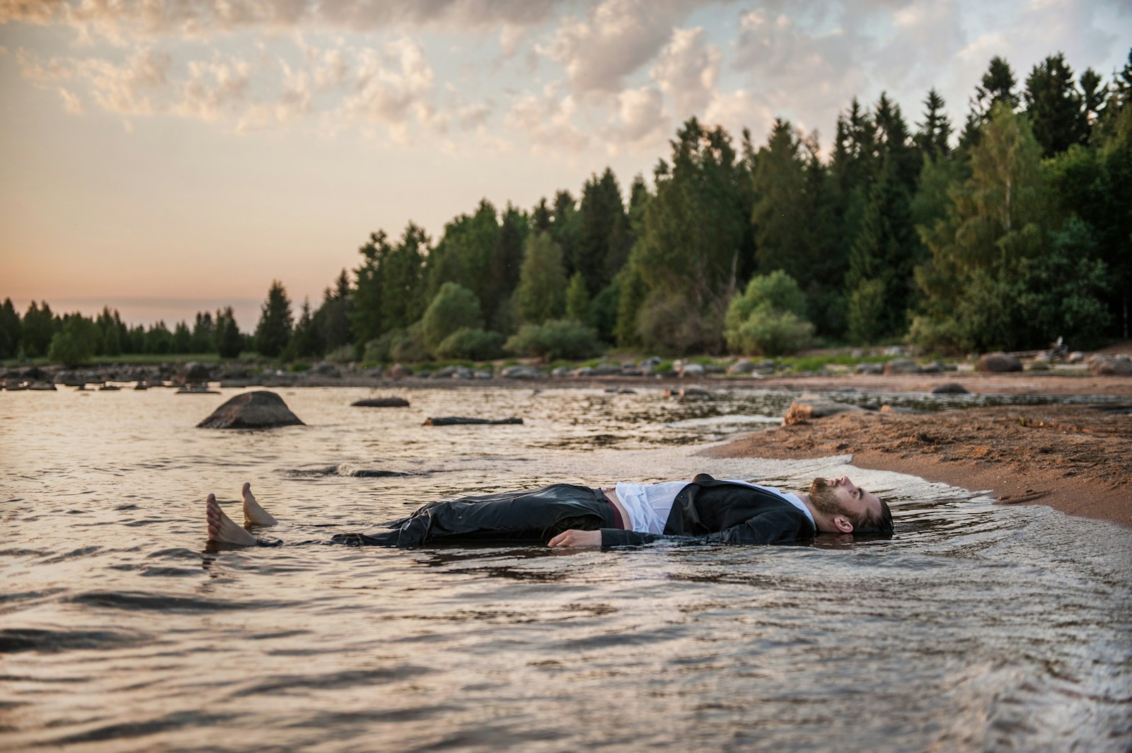 person lies in body of water