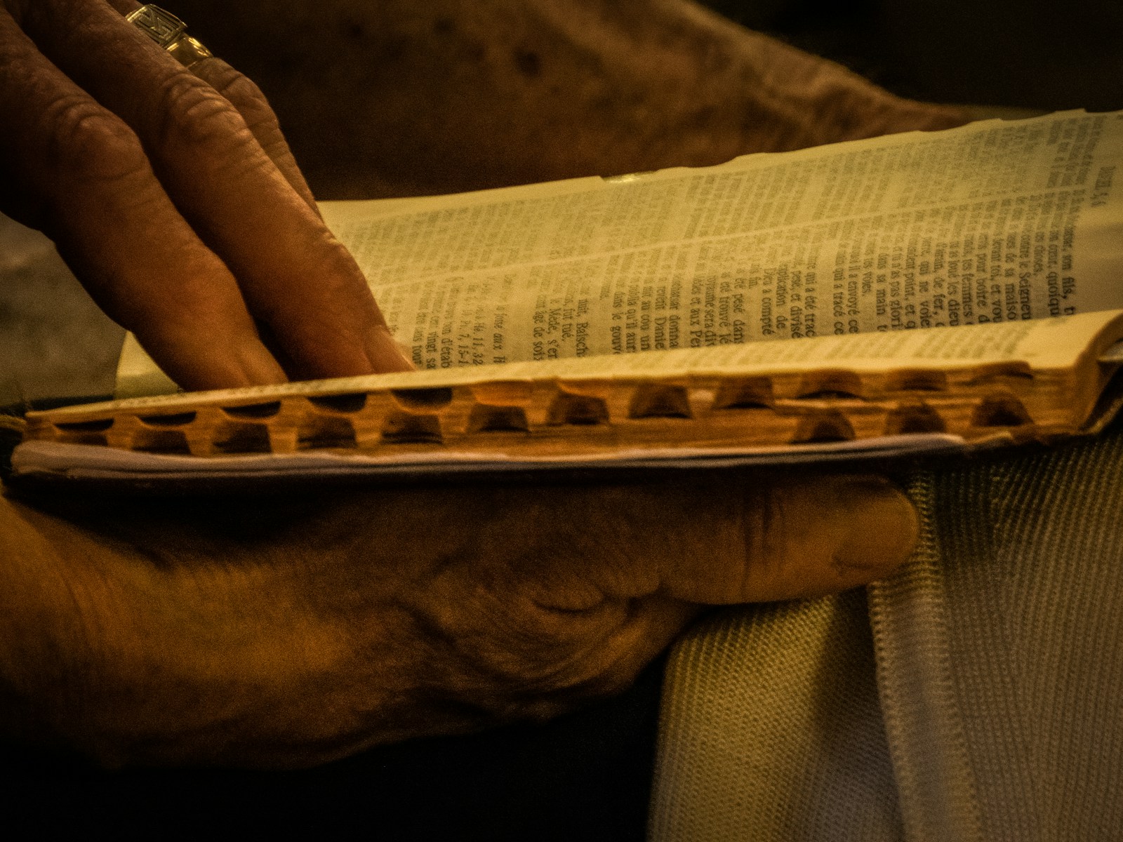 person holding brown and beige textile