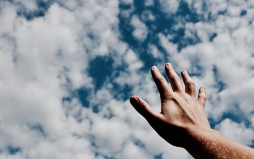person hand reaching for the sky
