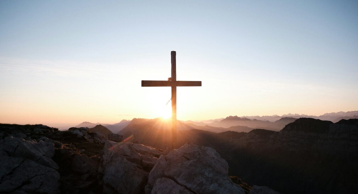 brown cross on brown rock during daytime