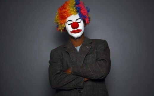 Vibrant clown portrait with face paint and colorful wig, perfect for circus or arts themes.