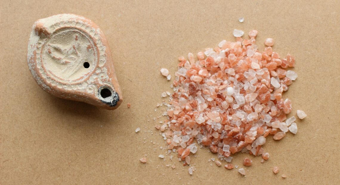 a pile of sea salt next to a small piece of stone