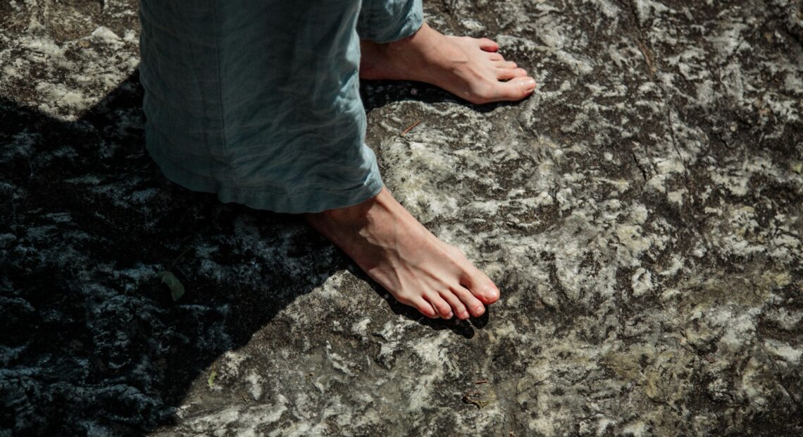 a person standing on top of a large rock