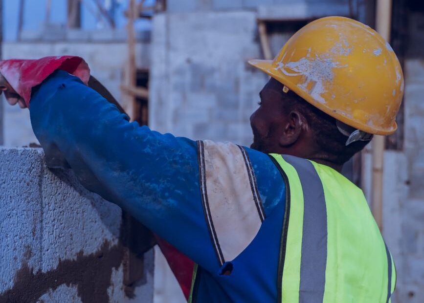 construction worker building a concrete wall